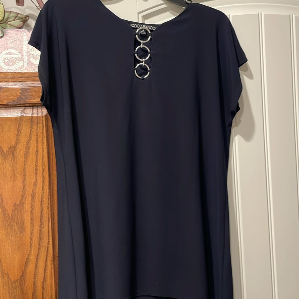 Cute top with silver rings. Wash and wear -no wrinkles.